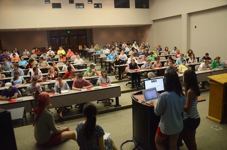 Anna Goodman, freshman broadcast journalism major, and Savannah Hari, junior sports medicine major, take role at the Senate meeting to make sure the representatives from the organizations are in attendance. - Photo by Matt McDaniel