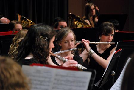 Quinlan Draper, freshman psychology major, plays in the symphonic band concert in the chapel.  - Photo by Anne Richoux