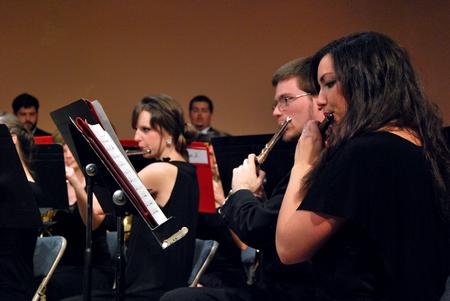 From right, Rachel Robbins, junior music and psychology major, and Andrew Hamaker, junior English major, perform in the symphonic band concert. - Photo by Anne Richoux