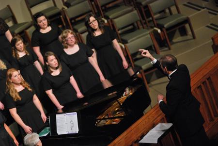 David Dennis, professor of music, directs the women's choir during the Spring Choral Concert at First Baptist Church.  - Photo by Anne Richoux