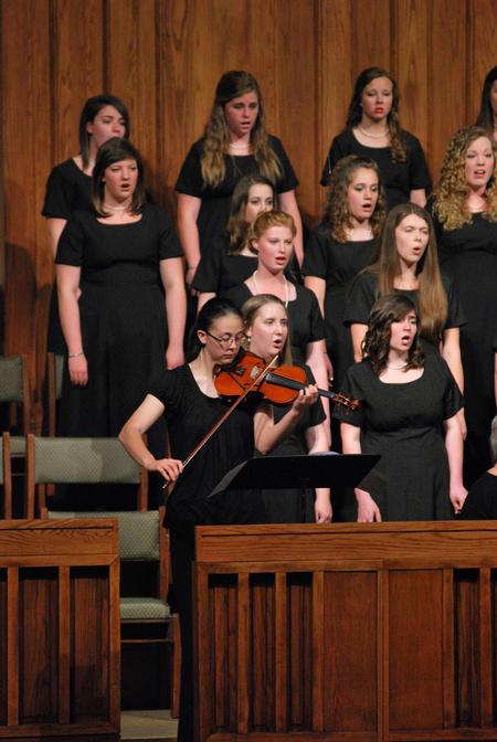 Paige Tang plays the violin along with the women's choir during the Spring Choral Concert at First Baptist Church.  - Photo by Anne Richoux