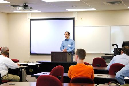 Daniel Stands, senior Biblical languages major, speaks to students and faculty about his research findingsduring the Scholarship Symposium. - Photo by Anne Richoux