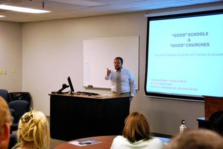 Tyler Glodjo, intercultural studies graduate student, presents his research project during the 10th annual Scholarship Symposium. - Photo by Anne Richoux