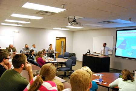 Tyler Glodjo, intercultural studies graduate student, presents his research project during the 10th annual Scholarship Symposium. - Photo by Anne Richoux