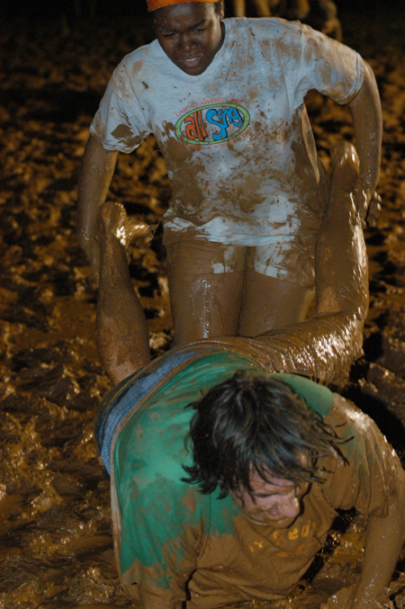 Juniors Holly Burnett and Lewis Curd work together in the wheelbarrow race during the Young Alum's Midnight Mudness. - Photo by Jonathan Blair