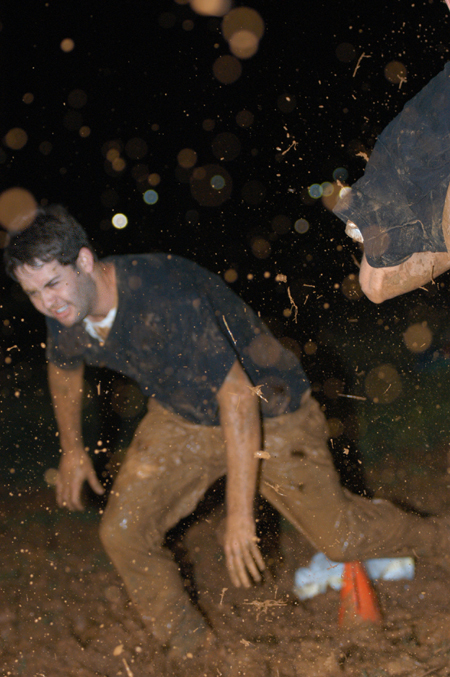 Junior Russell McNab gets down and dirty at the Young Alums' Midnight Mudness. - Photo by Jonathan Blair