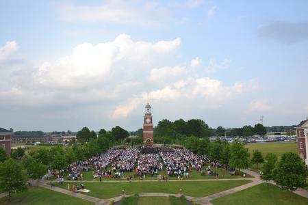 The great lawn is filled with guests and graduates at the beginning of Spring Graduation. - Photo by Olivia Wallace