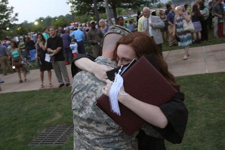 Holly Owens, graduate of music and english, hugs her fiancé after receiving her diploma during Spring Graduation. - Photo by Matt McDaniel