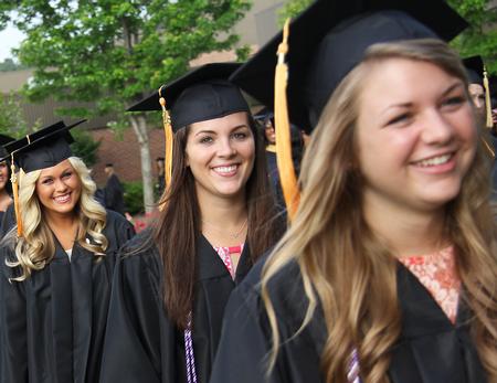 Nursing graduates Morgan Smith, Katherine Smith and Emily Smith walk to the Great Lawn during the Spring Graduation processional. - Photo by Matt McDaniel