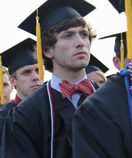 Wil Sloan, history graduate, listens to the announcements by David S. Dockery, president of the university. - Photo by Matt McDaniel