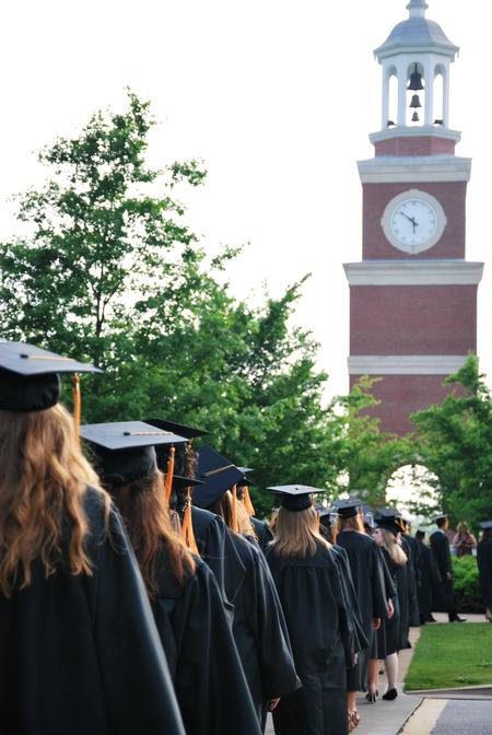 Graduates walk toward the Great Lawn during the processional at Spring Graduation.  - Photo by Anne Richoux