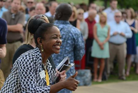 Renee Jones, associate director of the Vocatio Center for Life Calling and Career, congratulates a graduate during the commencement processional held on the Great Lawn. - Photo by Jacob Moore