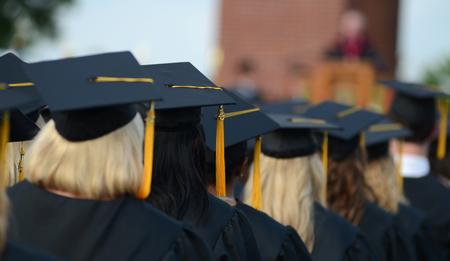 Graduates listen to David S. Dockery's welcome during Spring Graduation on the Great Lawn. - Photo by Jacob Moore