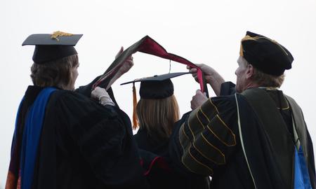 Doctoral graduates receive their hoods during Spring Graduation on the Great Lawn. - Photo by Jacob Moore