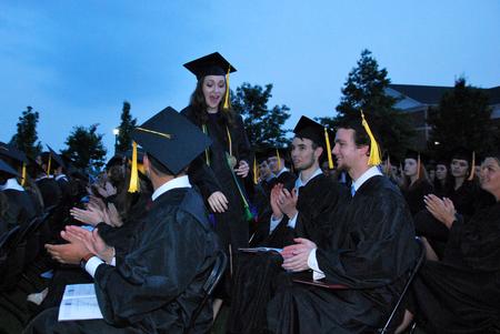 Rachel Carbonell, shows surprise and excitement as she makes her way to the stage to receive the Tigrett Medal during Spring Graduation.  - Photo by Anne Richoux