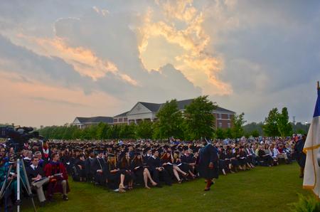 Graduates make their way back to their seats after receiving diplomas at Spring Graduation.  - Photo by Morris Abernathy