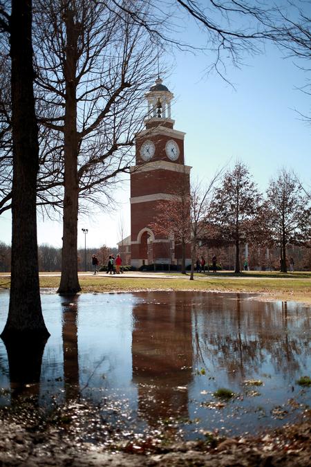 Miller Tower is reflected in a pond of water after several days of rain.  - Photo by Kristi McMurry Woody