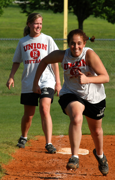 Amy Mejia (19) races toward home during a Union practice.  Katie Tipton (15) stands next in line. - Photo by Jonathan Blair
