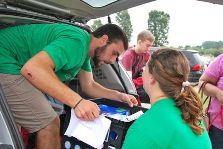 Life Group leader Chris Hare, sophomore DMS major, helps unpack a car on new student move-in day. - Photo by Anne Richoux