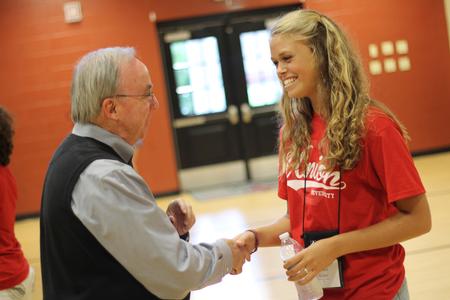 Grace Carter, freshman, shakes hands with David S. Dockery, president of the university, at the beginning of the annual ice cream social in the Bowld Student Commons. - Photo by Matt McDaniel