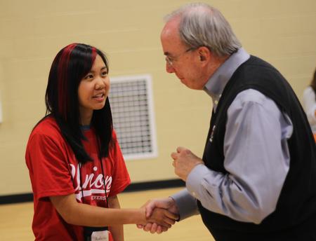 David S. Dockery, president of the university, greets freshman Katherine Cheshire at the annual ice cream social event held in the Bowld Student Commons.  - Photo by Matt McDaniel