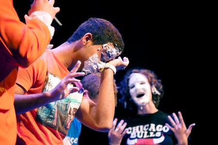 After scarfing down a pie without using their hands at the annual Student Activities Council Game Show during Focus weekend, new students wipe whipped cream from their faces. - Photo by Amanda Rohde