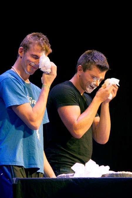 After finishing a challenge at the Student Activities Council Game Show during Focus weekend, new students wipe whipped cream off their faces. - Photo by Amanda Rohde