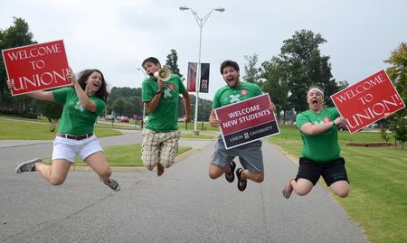 LifeGroup leaders Emily Williams, Casey Mack, Christian Shipman and Kensie Zills greet new students and their families pulling into campus for new student move-in day. - Photo by Jacob Moore