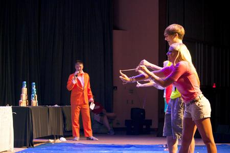 New students attempt to demolish a tower of soda cans with rubber bands during the SAC Game Show. - Photo by Amanda Rohde