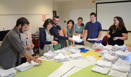 At right, Melinda Posey, assistant professor of art. leads graphic design students in an interactive example during class in Jennings Hall. - Photo by Jacob Moore