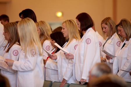 The pharmacy class of 2017 recites the pharmacist's code after receiving their white coats in a ceremony held in the G.M. Savage Memorial Chapel. - Photo by Kristi McMurry Woody