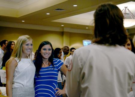 Excited class of 2017 pharmacy students take photos with their family and friends while celebrating at the reception for the sixth annual white coat ceremony. - Photo by Amanda Rohde