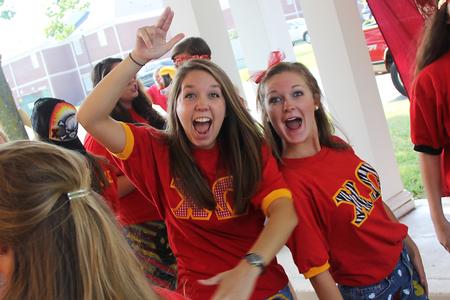 Katie Longworth, junior nursing major, and Kailin Wilson, sophomore, show some excitement during Panhellenic bid day. - Photo by Matt McDaniel