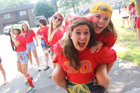 Katie Tansey, sophomore, holds Maggie Robertson, sophomore nursing major, on her back during bid day. - Photo by Matt McDaniel