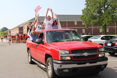 Several ladies of Kappa Delta drive up to the Kappa Delta house to join the excitement during Panhellenic bid day. - Photo by Matt McDaniel