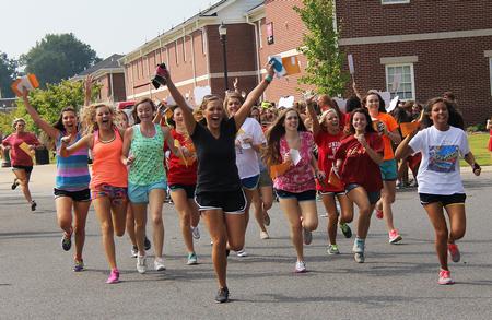 The new sorority members sprint to the houses to join their sisters during bid day. - Photo by Matt McDaniel