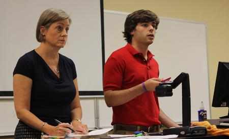 Brooke Emery, assistant professor of marketing, and Matt Street, senior management major, lead a meeting for Enactus, formerly known as SIFE. - Photo by Matt McDaniel