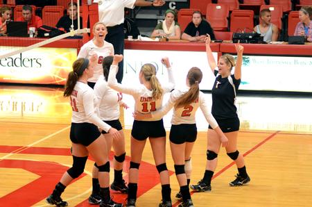 Members of the volleyball team celebrate after scoring a point against  Harding University. - Photo by Anne Richoux
