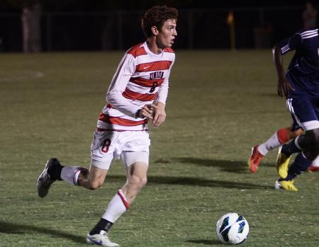 Clayton Martin, sophomore, dribbles the ball up the field during a game against the Lee University Flames. - Photo by Matt McDaniel