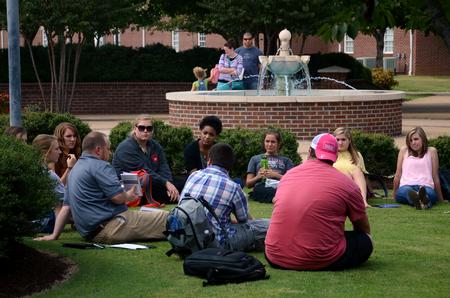 Ken Litscher, director of residence life, meets with a class outside the PAC on a beautiful afternoon. - Photo by Anne Richoux