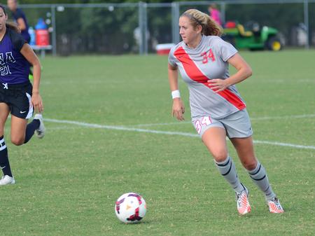 Rachael Boswell, senior athletic training major, dribbles past the defenders in the game against the University of North Alabama lady Lions. - Photo by Matt McDaniel