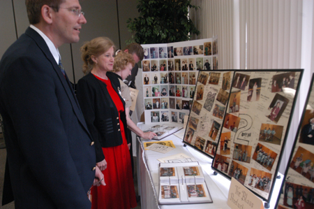 Music professors David Dennis and Diane Gatwood look over a photo display of Dr. Joe Blass' time at Union during a retirement reception in his honor. - Photo by Kristen Nicole Sayres
