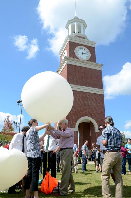 The Society of Physics Students prepares for the launch of a bobblehead of DSD into space. - Photo by Anne Richoux