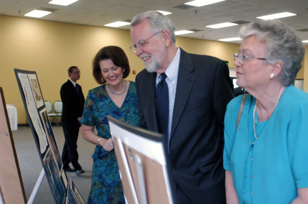 Becky Howard and Joe and Sue Blass look over a display of photos of Dr. Blass' time at Union during his retirement reception. - Photo by Kristen Nicole Sayres