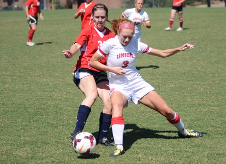 Kayleigh Patterson, freshman broadcast journalism major, fights for a ball against a Union alumnus at the alumni soccer game during Family Weekend. - Photo by Matt McDaniel