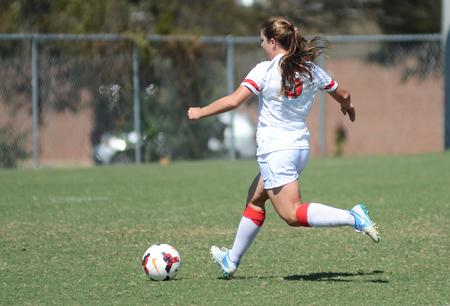 Kelsey Wilkes, freshman business administration major, scores a goal at the alumni soccer game during Family Weekend. - Photo by Matt McDaniel