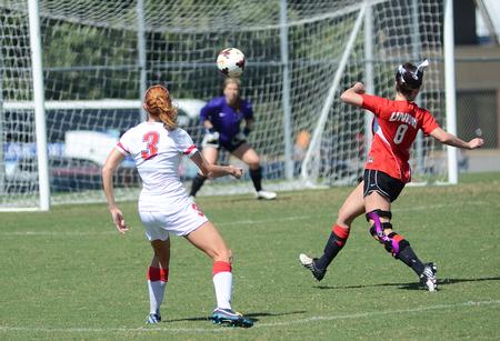 Kayleigh Patterson, freshman broadcast journalism major, takes a shot on goal at the alumni soccer game. - Photo by Matt McDaniel