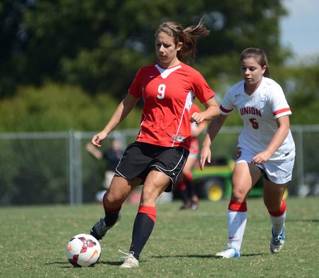 Whitney Kramer, Union alumnus, passes to a teammate at the alumni soccer game during Family Weekend. - Photo by Matt McDaniel