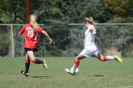 Emily Crane, senior athletic training major, shoots at the goal during the Family Weekend alumni soccer game. - Photo by Matt McDaniel