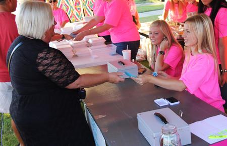 Emma Hopkins, sophomore nursing major, takes up tickets at the Zeta Tau Alpha shrimp boil during Union Night. This event has become a tradition during Family Weekend.  - Photo by Matt McDaniel